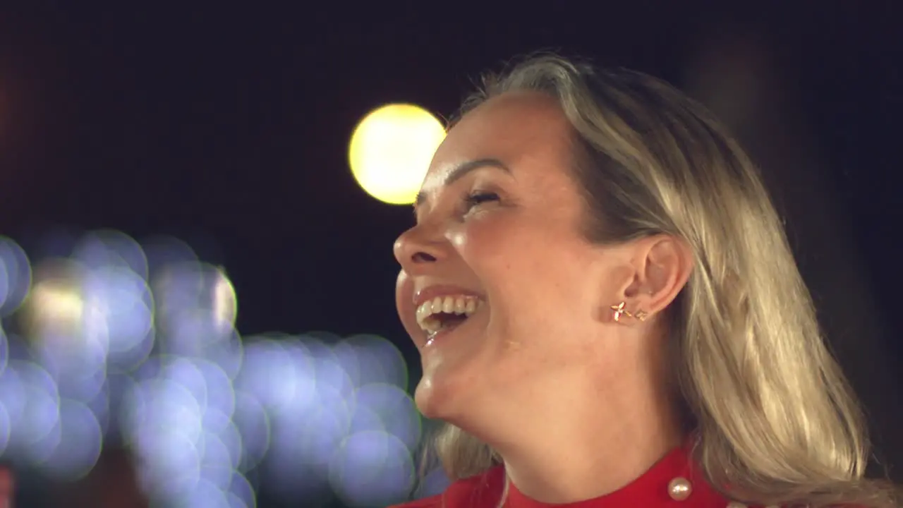 Happy laughing woman with a pretty face at a bar restaurant or nightclub