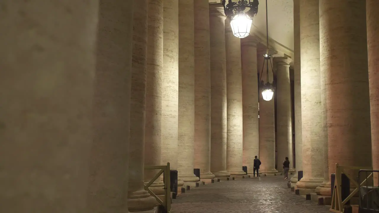 Tourists Walking Down Colonnade