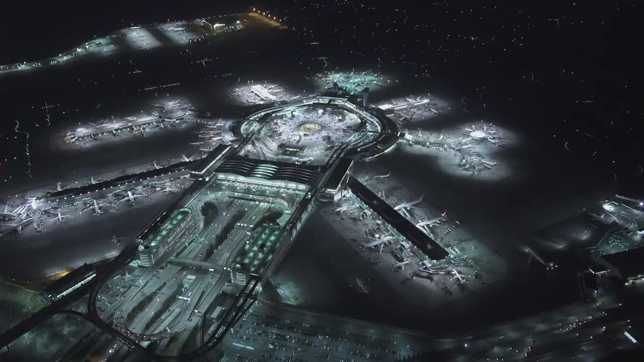 Aerial view of a large airport hub at night