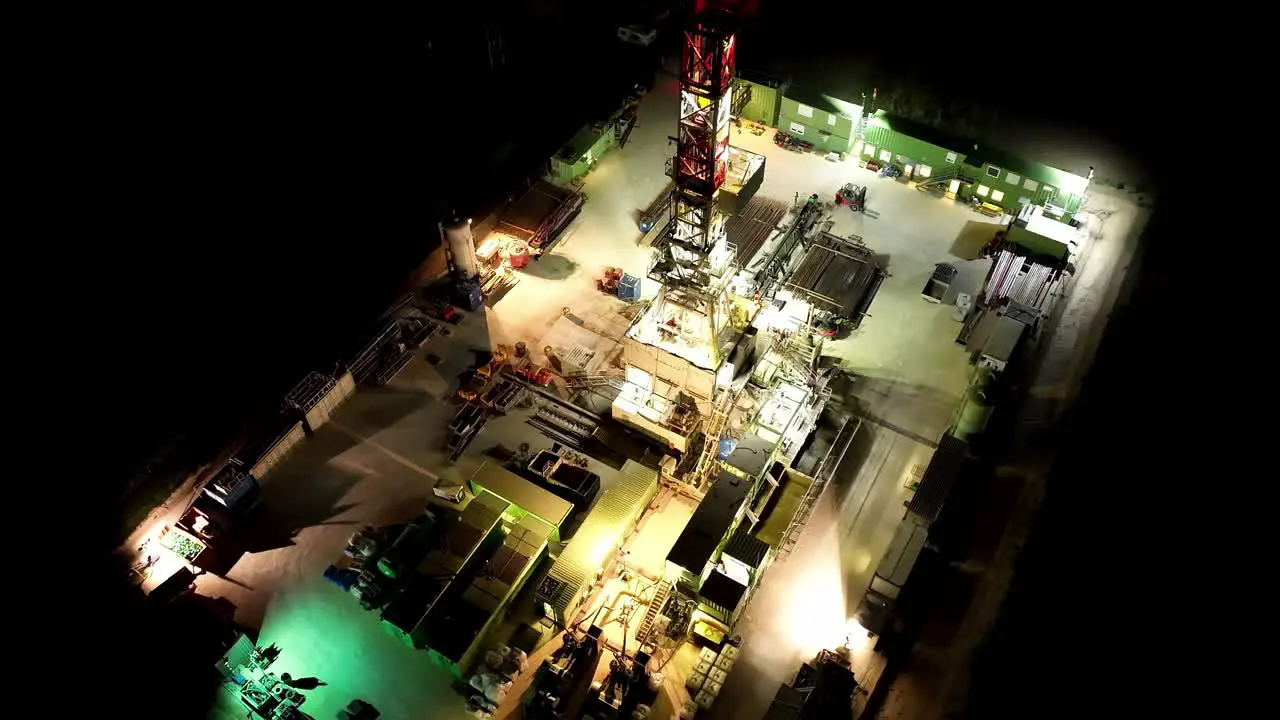 Bird's Eye View Of Gas Drilling Station At Night aerial drone shot