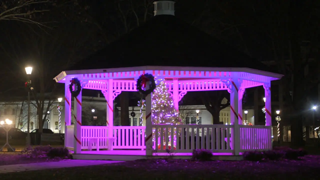 Wooden Gazebo Illuminated By Christmas Lights With Wreath At Night