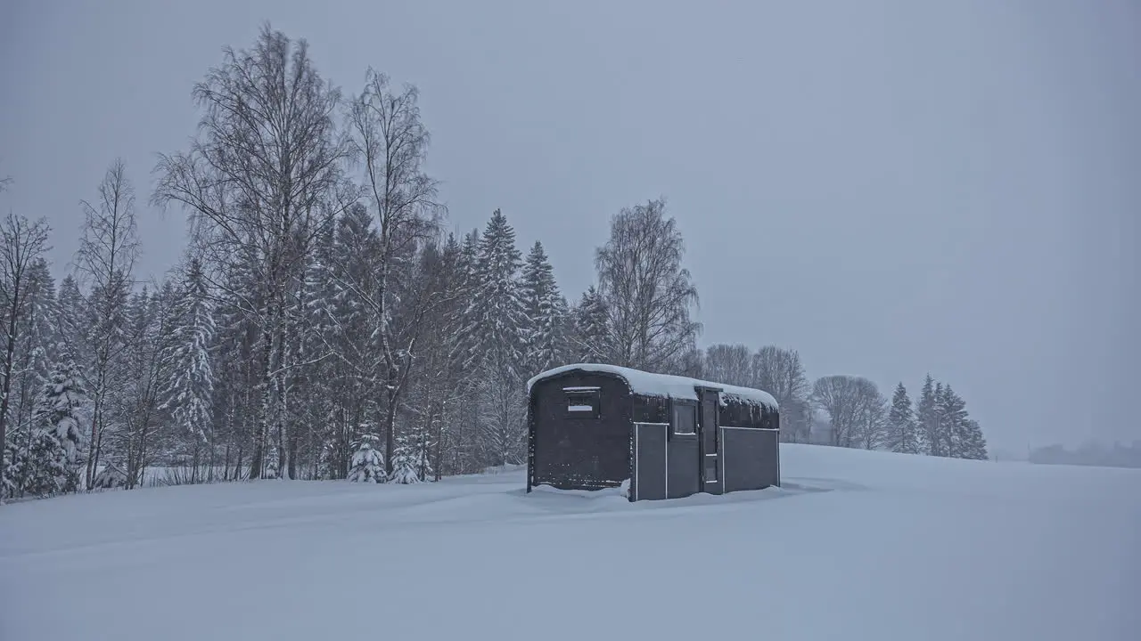 Small cabin in snow storm in remote landscape Timelapse