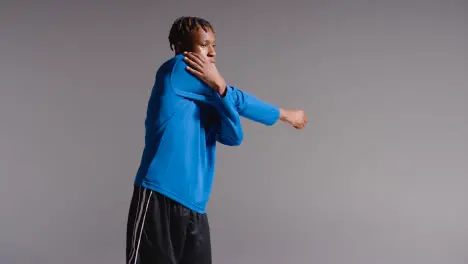 Studio Portrait Of Young Man Playing Football Or Other Sport Walking To Training With Kit Bag And Exercising