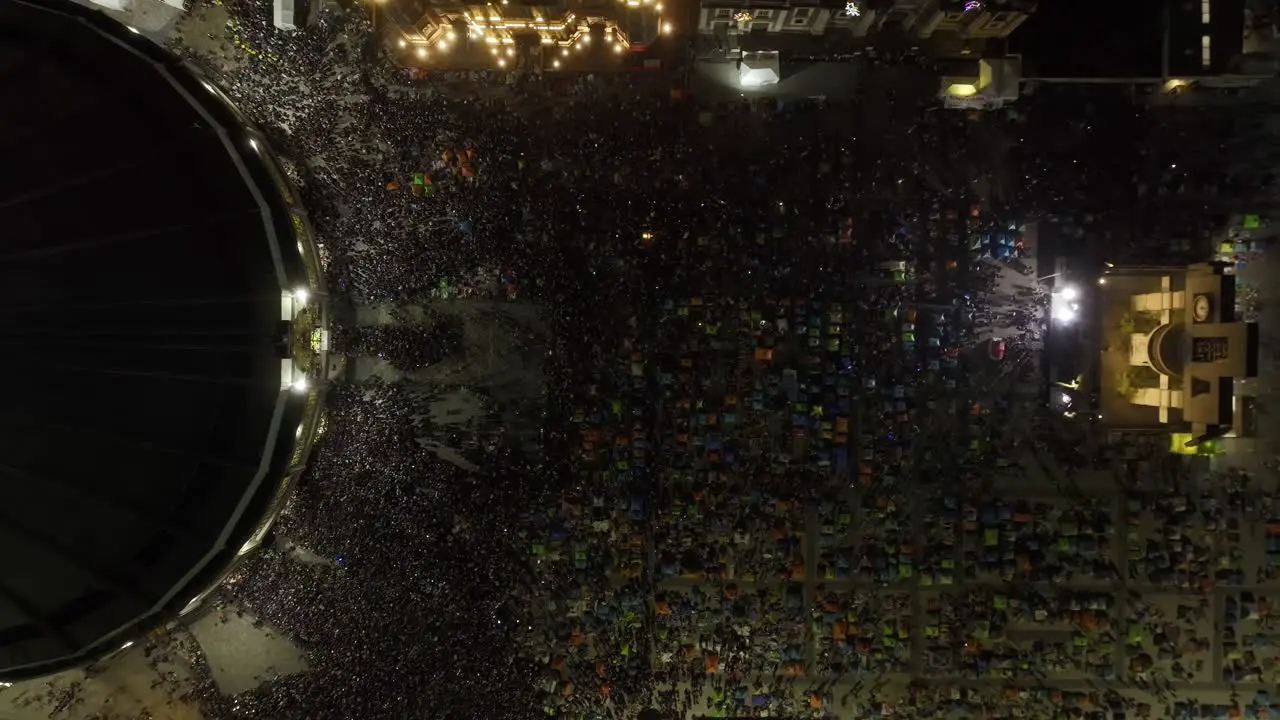 Aerial view above people on the Plaza Mariana at the Basílica de Guadalupe Pilgrimage Virgin Day night in Mexico top down drone shot