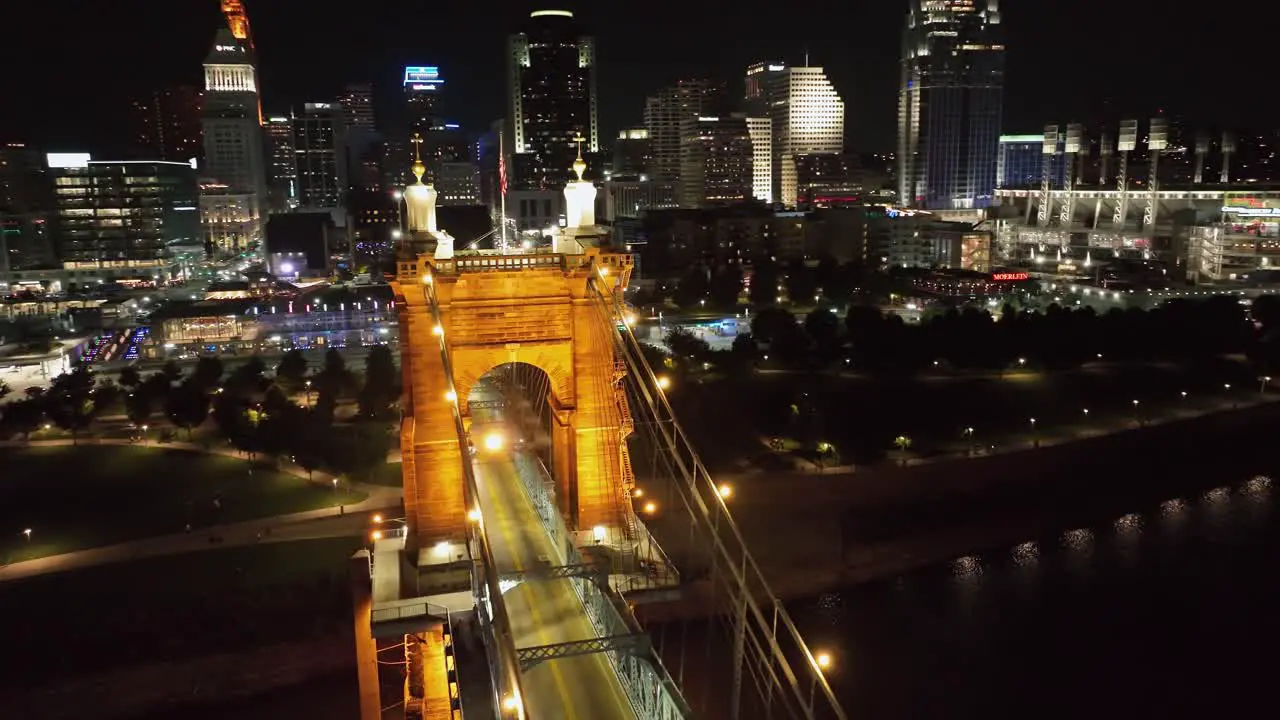 Car driving on the illuminated Roebling Bridge in Cincinnati USA aerial view