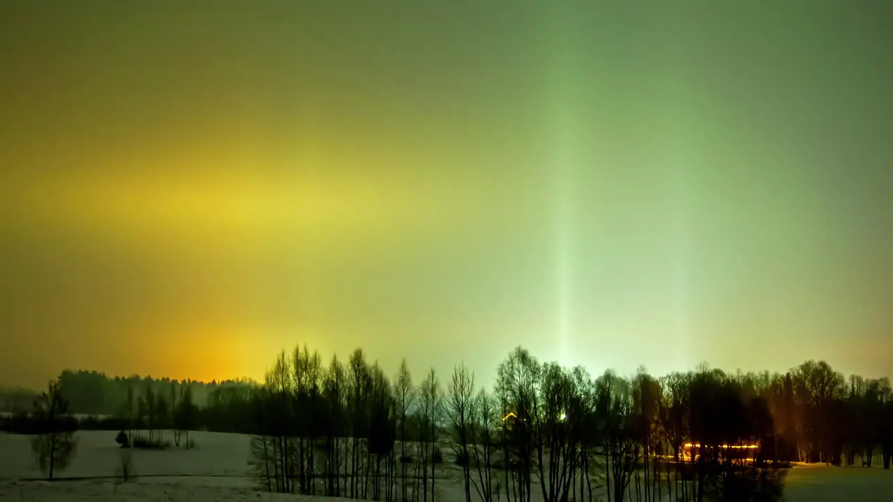 Aurora borealis over a winter countryside farmhouse colorful nighttime time lapse