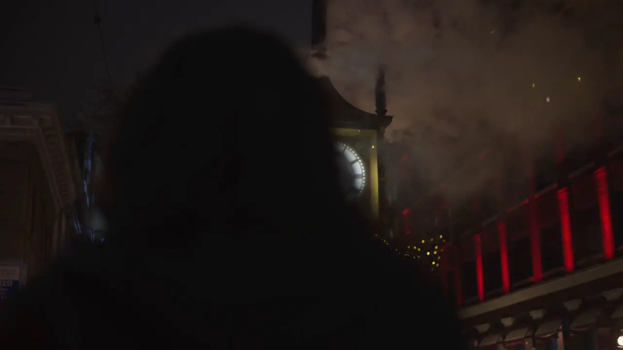 OVER THE SHOULDER SHOT of Photographer Taking Pictures of Gastown Clock in Snowy Nighttime Scene