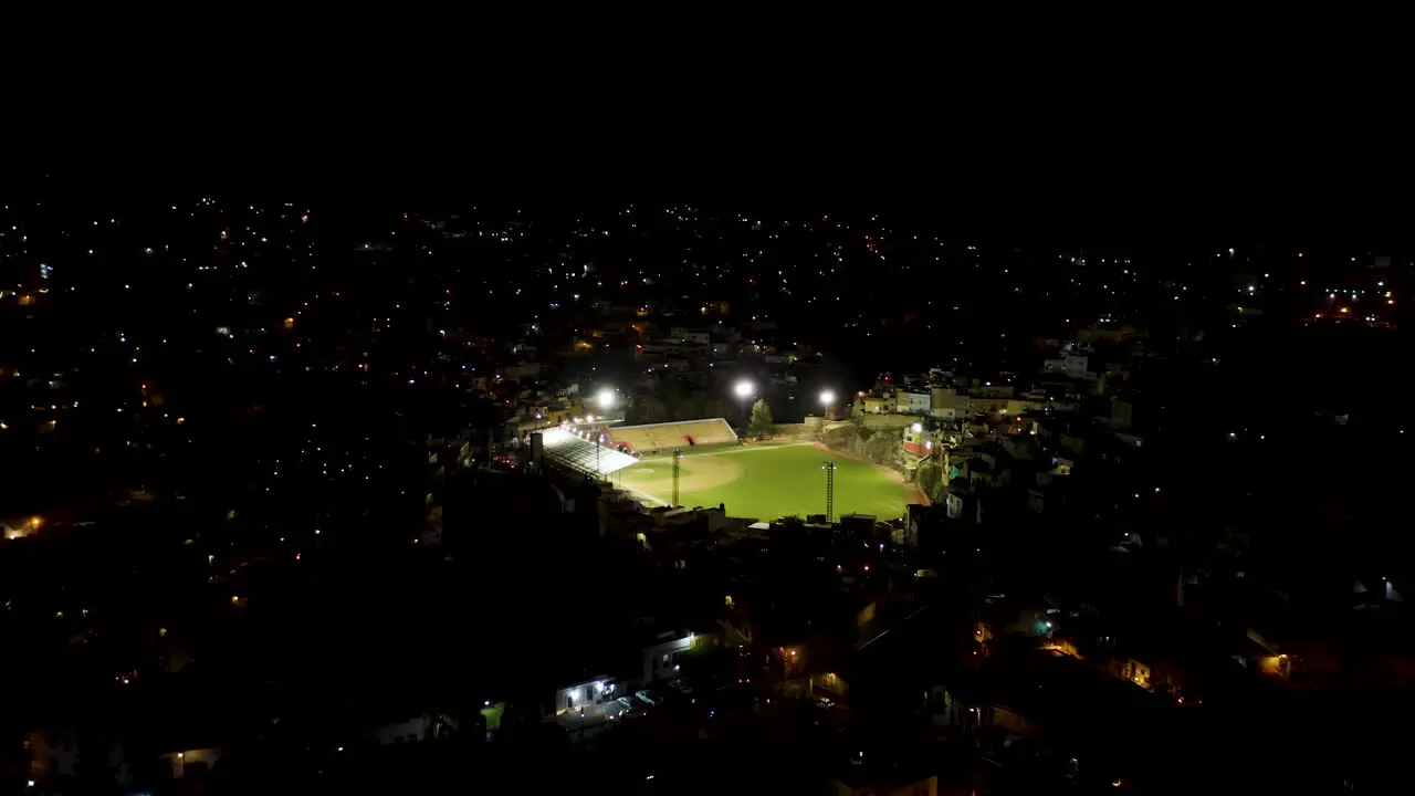 Drone Flies Toward Baseball Stadium at Night