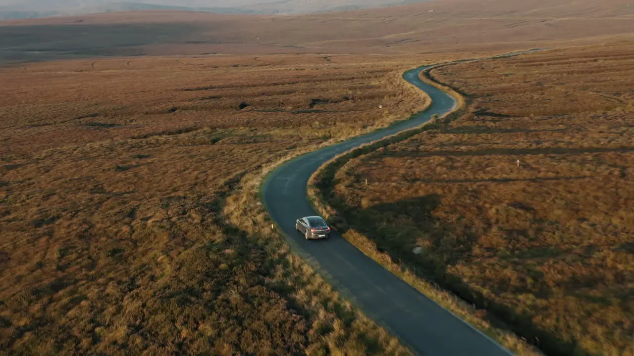 Aerial view car driving through the wicklow mountains Ireland