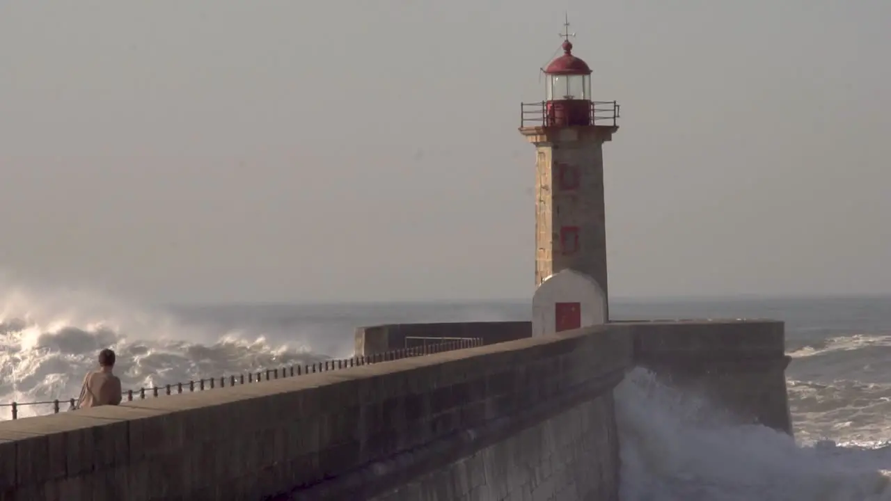 ocean big waves crash over the lighthouse