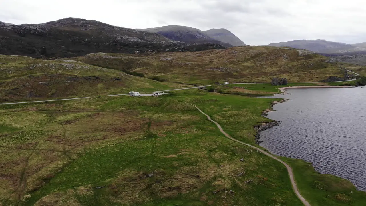 Aerial descending shot from Loch Assynt looking towards the mountains of the Scottish Highlands