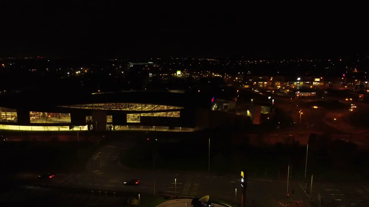 Night traffic headlights driving British town highway intersection aerial view