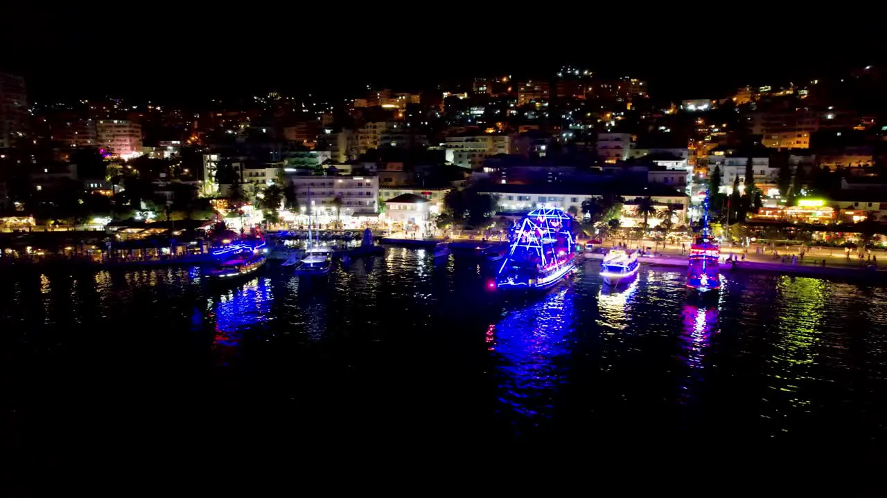 Beautiful Bay of Saranda at Night Illuminated by Promenade Lights with Anchored Tour Ships Creating a Magical Summer Vacation Scene