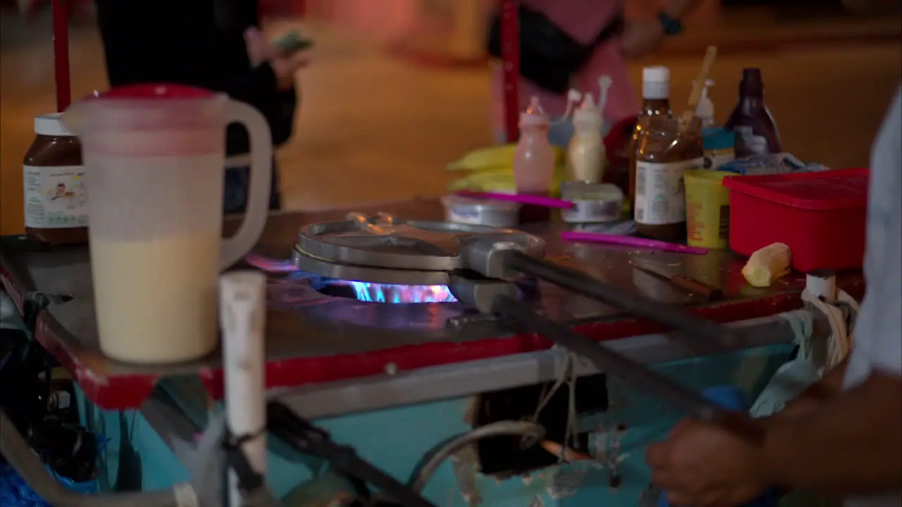 Close up of the grill stove of a street cook preparing a typical snack of yucatan cancun Mexico called Marquesitas