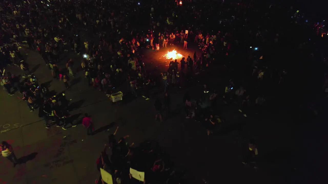 Aerial view of a riot people burning stuff on the streets of Mexico city during nighttime