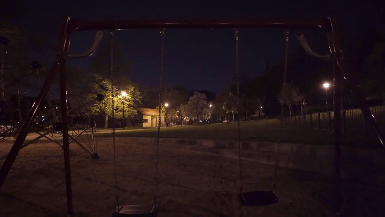 Empty swings climbing bars playground at night Prague Czechia during lockdown