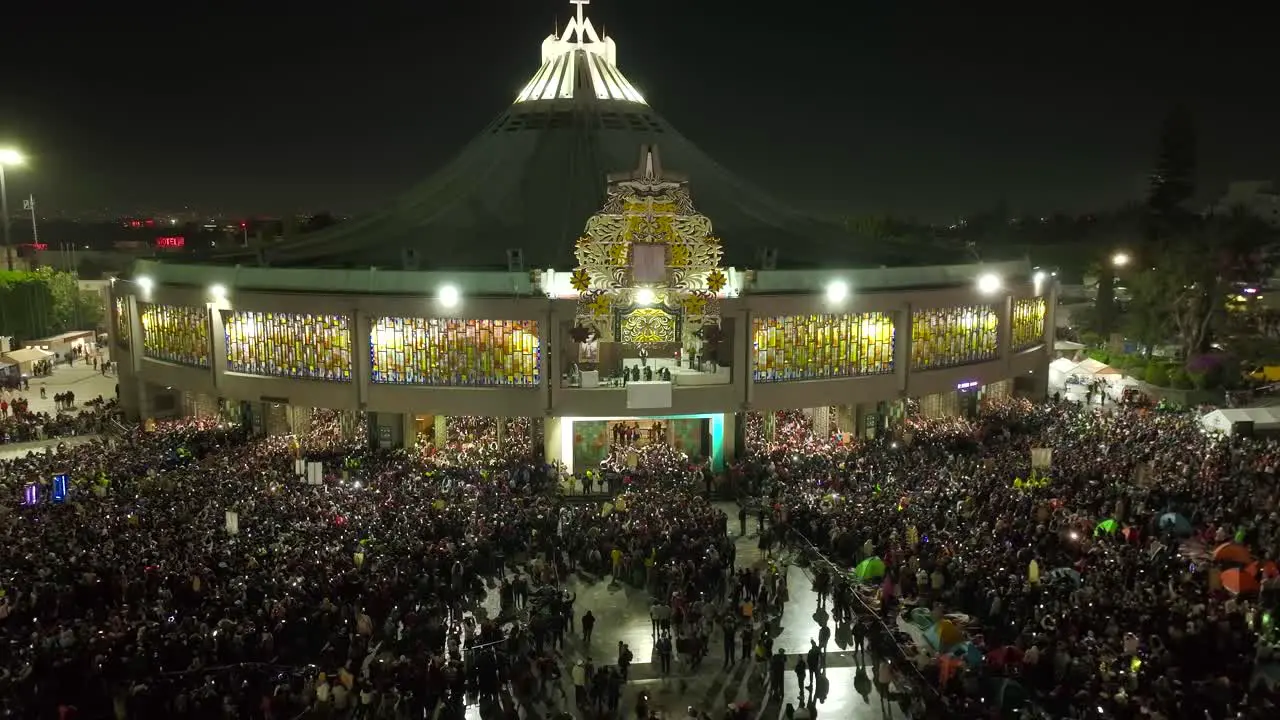 Aerial view away from the evening lit Basilica of Guadalupe nighttime in Mexico