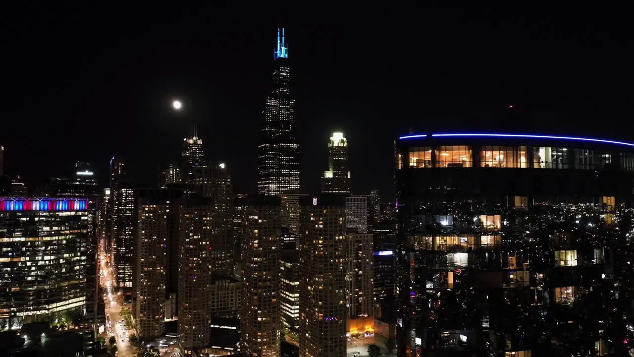 Glossy apartment building full moon above the West Loop Chicago skyline Aerial view