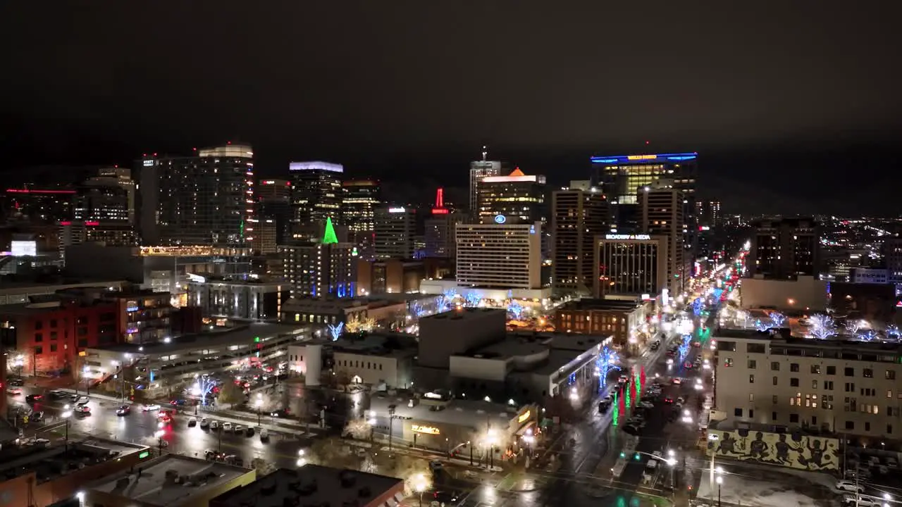 Salt Lake City skyline on a misty nighttime with Christmas lights glowing push in aerial