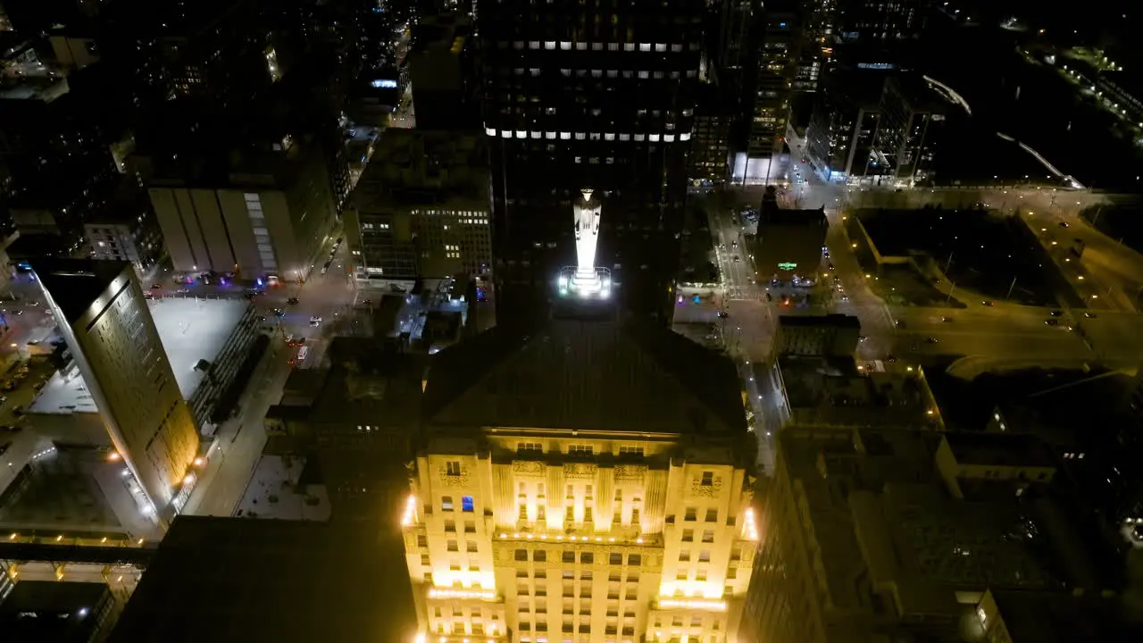 Aerial view approaching towards the Ceres statue on top of the illuminated Board of Trade tower in Chicago USA