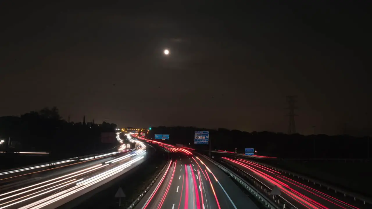 Timelapse view of a highway near Barcelona full moon during night time in Spain