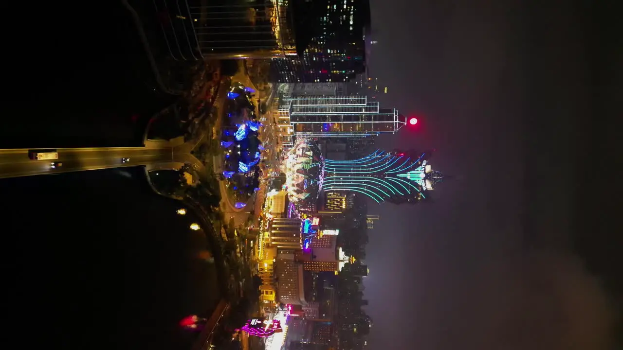 Vertical aerial view approaching Grand Lisboa Hotel at night