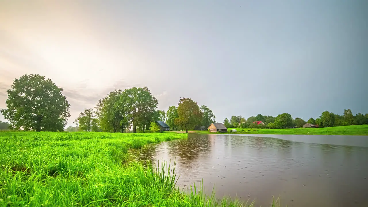 Timelapse Yellow Sunset Day to Night Evening Thunderstorm Over Lake and Countryside Latvia