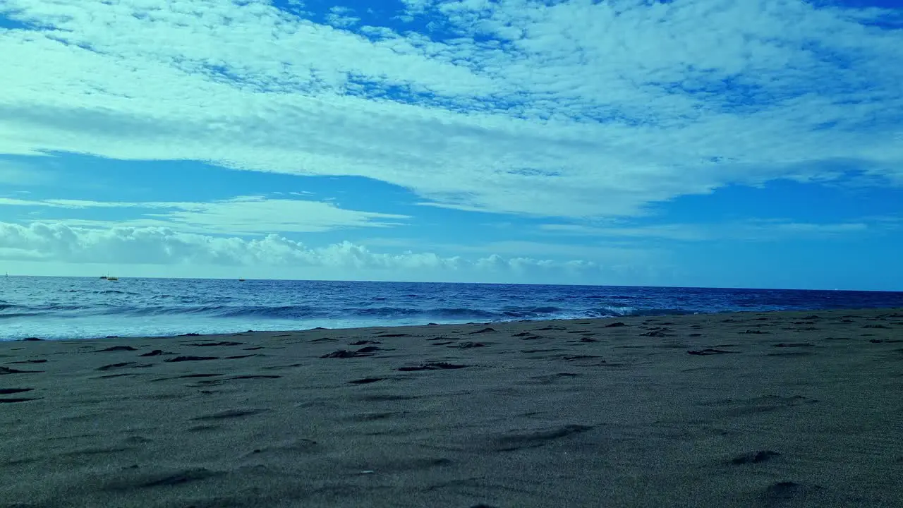 Shot of waves crashing on El Medano beach Tenerife Canary Islands Spain on a sunny day