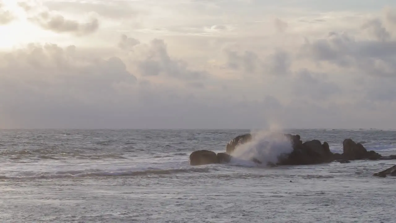 Sea Waves Crashing on to rocks in distance evening Galle fort Seashore Slow mo b roll clip