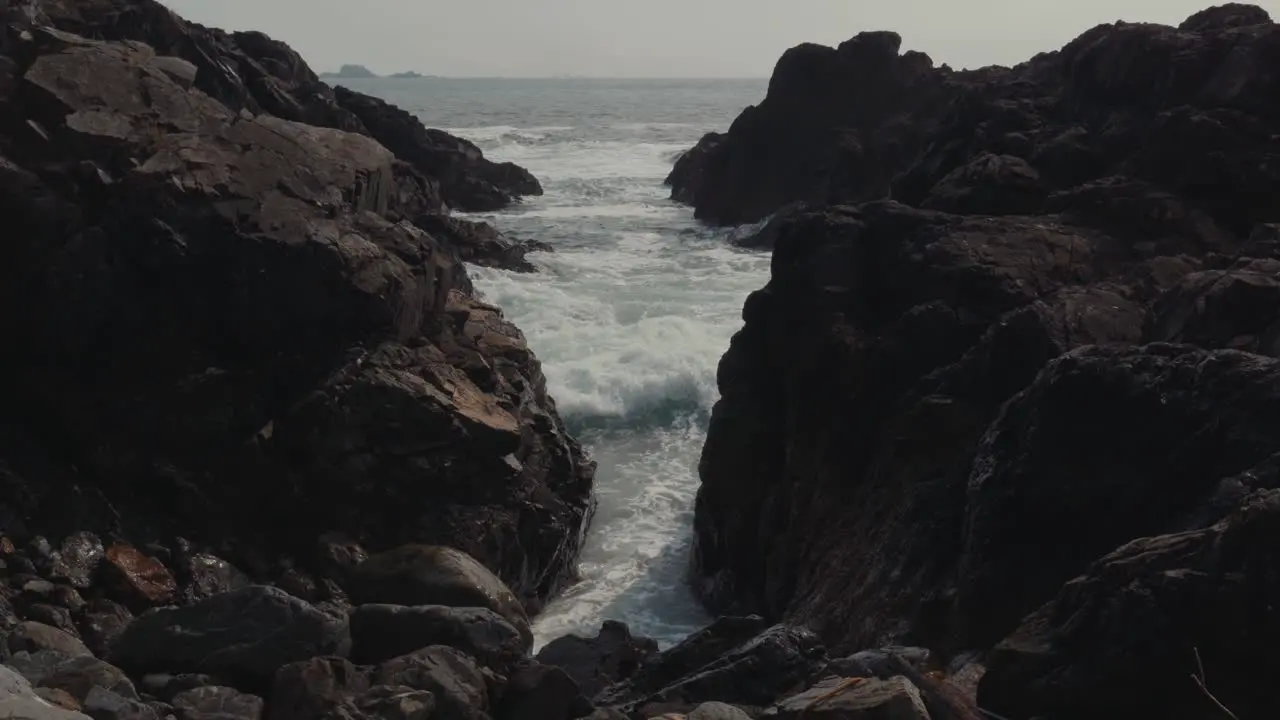 Waves Forming and then Crashing through a Tunnel of Rocks in Ucluelet