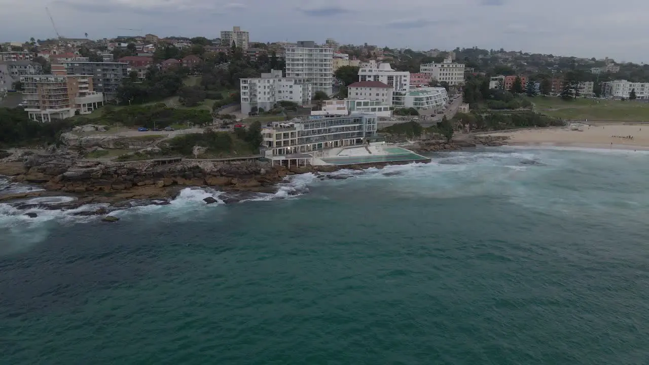 Waves Crashing On Bondi Icebergs Pool At Bondi Icebergs Club Eastern Suburbs With Tourist Surfing On Bondi Beach In New South Wales Australia