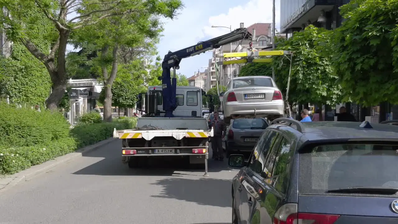 Tow Truck Lifting And Loading Car In Burgas Bulgaria rearview static shot