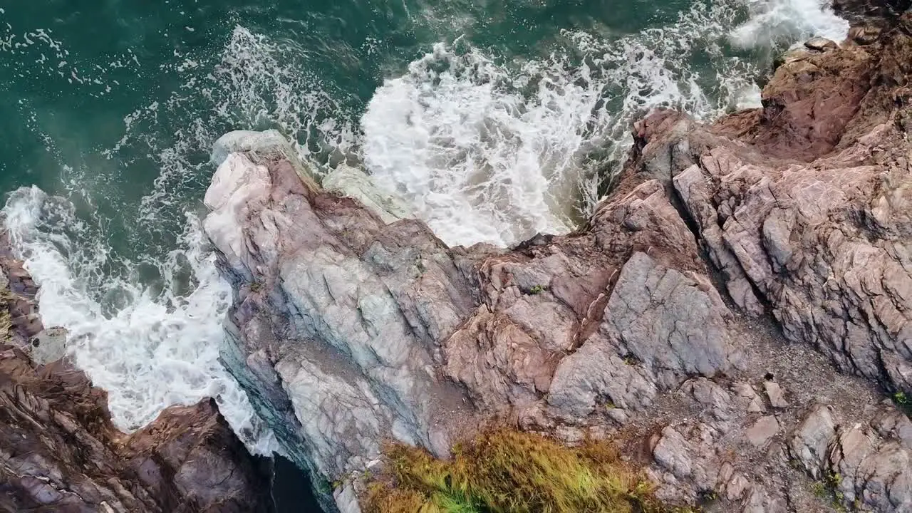 Drone footage of waves crashing on the rocky coast of Rhode Island