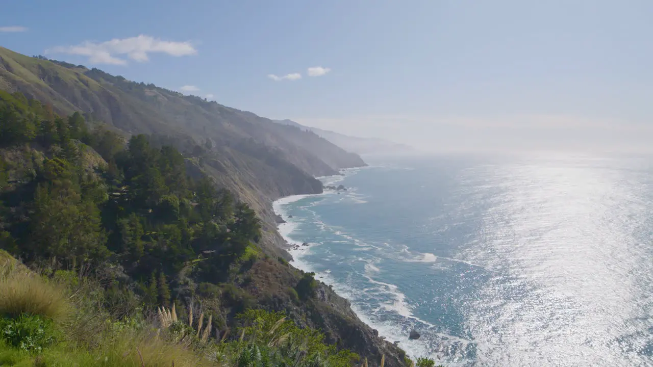 Time Lapse shot of mountainside view of Pacific ocean with waves crashing along the beach located in Big Sur California