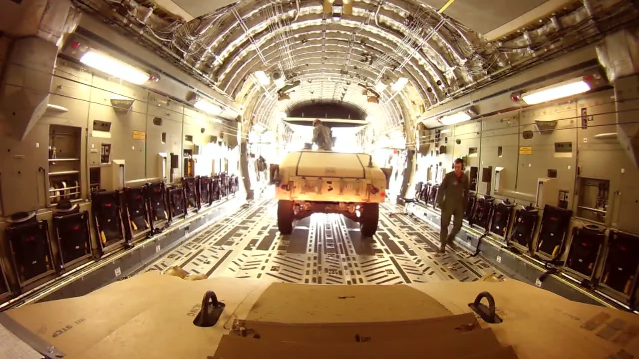 Pov Of A Humvee As It Drives Out Of The Cargo Hold Of A C17