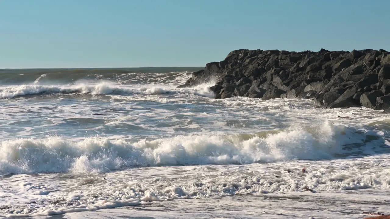 Breakwater crashes against jetty in Gold Beach Oregon coast