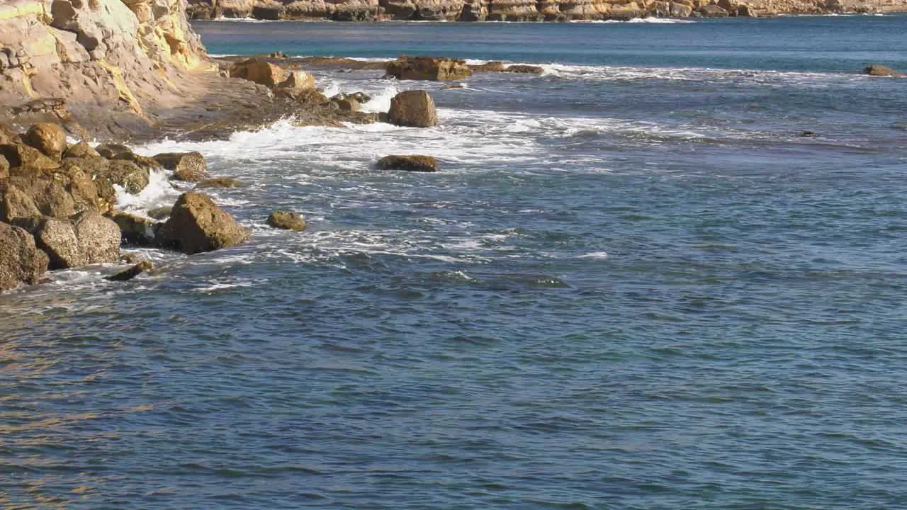 Ocean waves break on coastal sea cliffs mediterranean