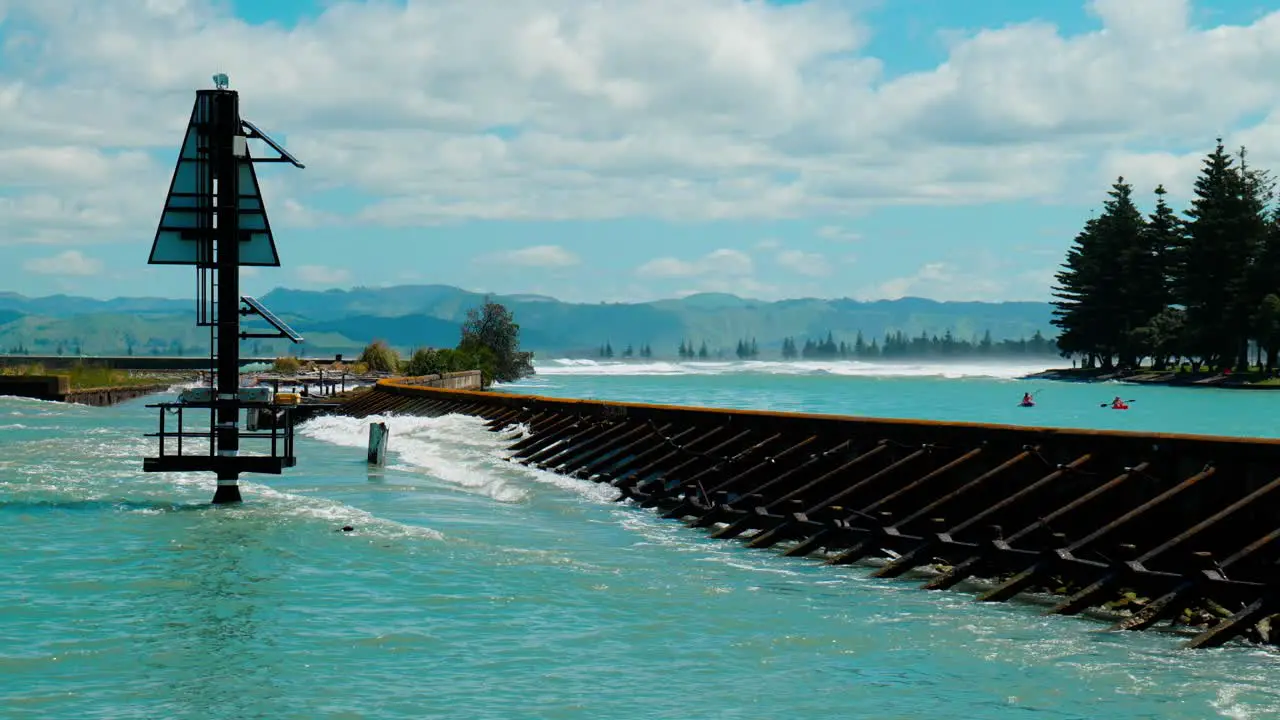 Capture the mesmerizing spectacle of powerful waves relentlessly crashing against a rugged harbour wall showcasing the raw beauty and force of nature's unyielding power