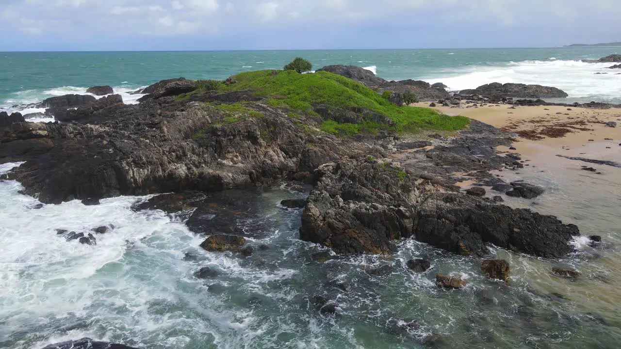 Rugged Green Headland With Foamy Waves Crash Onto Rocks At Sawtell Beach Near Bonville Headland Lookout In New South Wales Australia