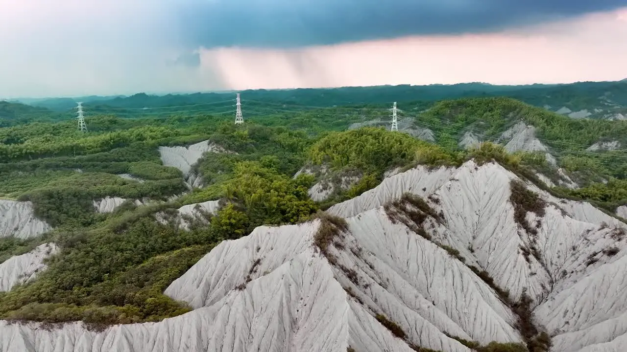 Transmission tower in the old mud volcano area of Tianliao during misty day in Taiwan Aerial forward flight