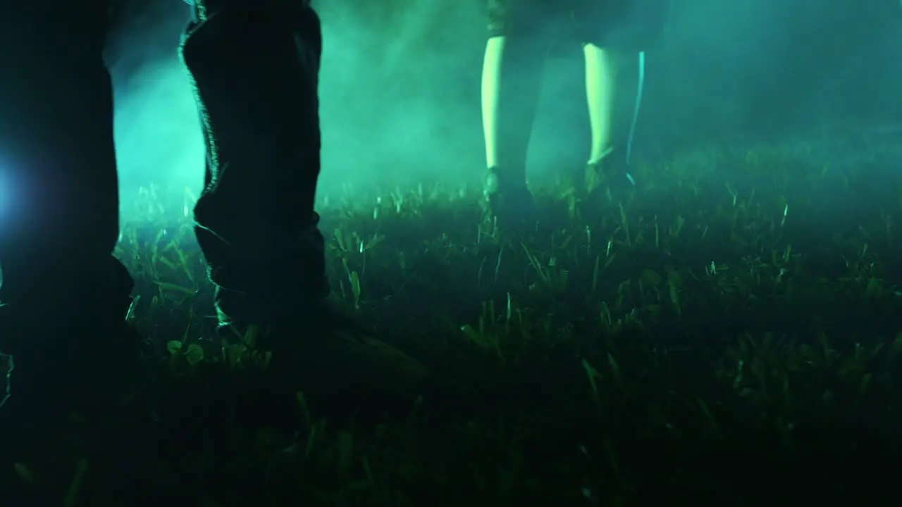 Three kids walk through foggy grass towards camera