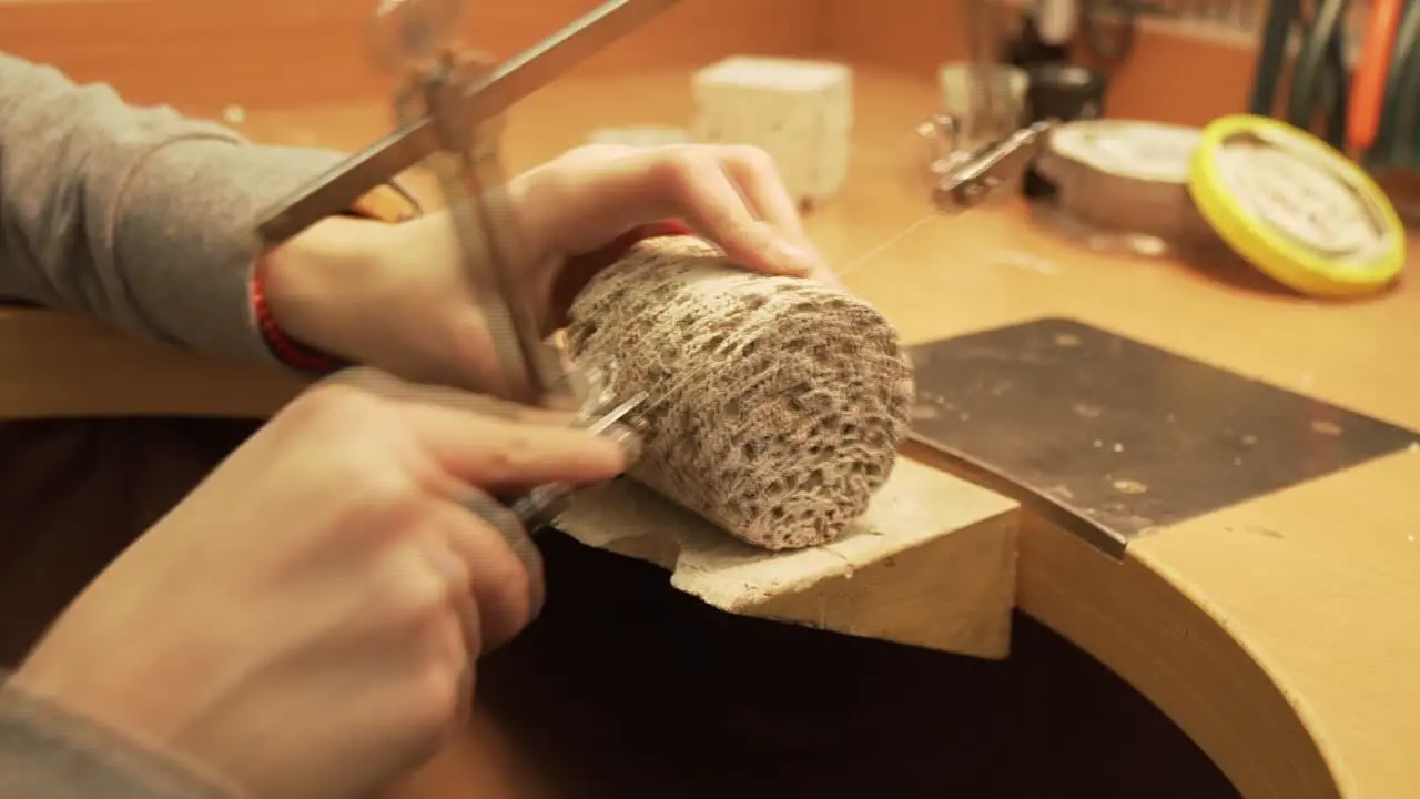 Detail of cutting geopolymer cylinder with string saw shot from workroom