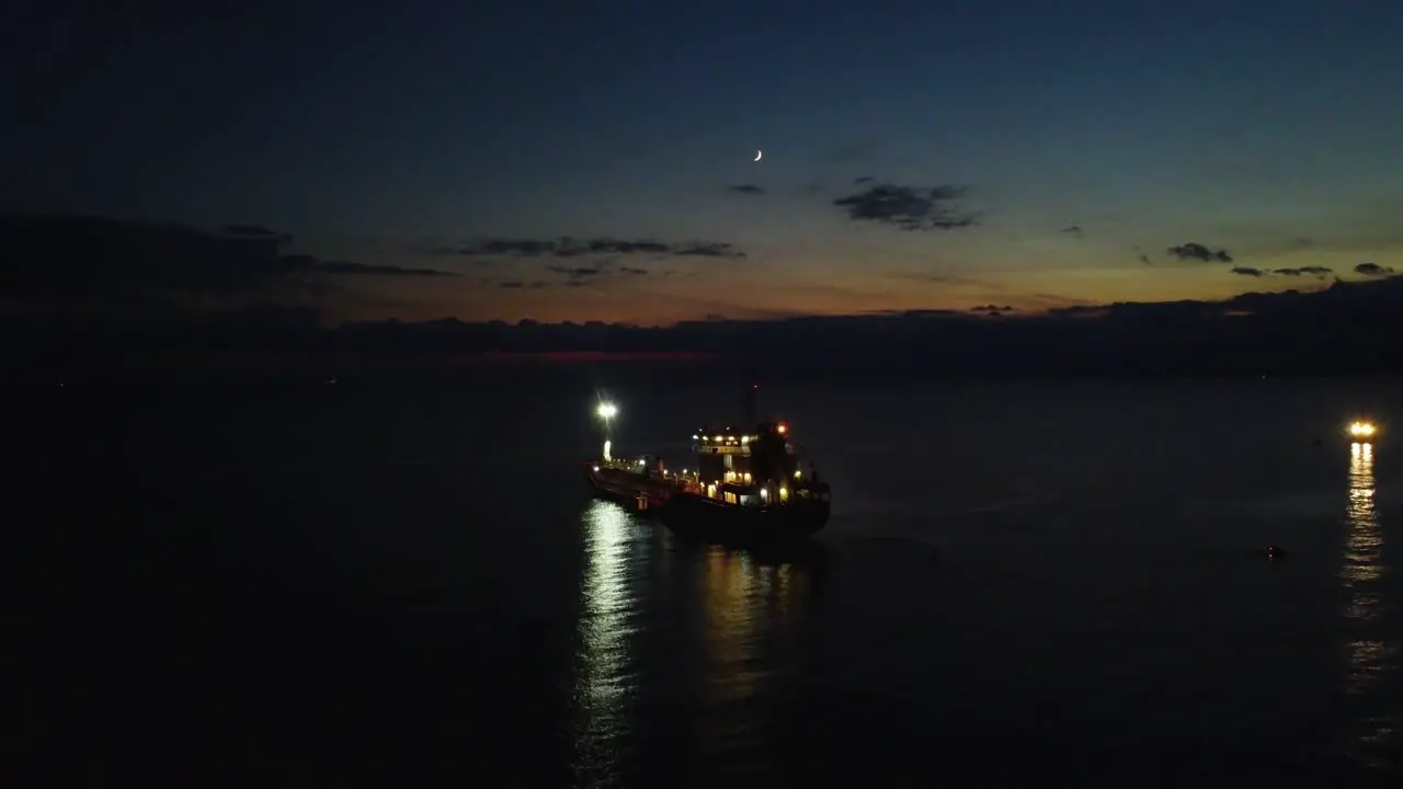 Aerial view of boat oil tanker in the ocean at dusk night view