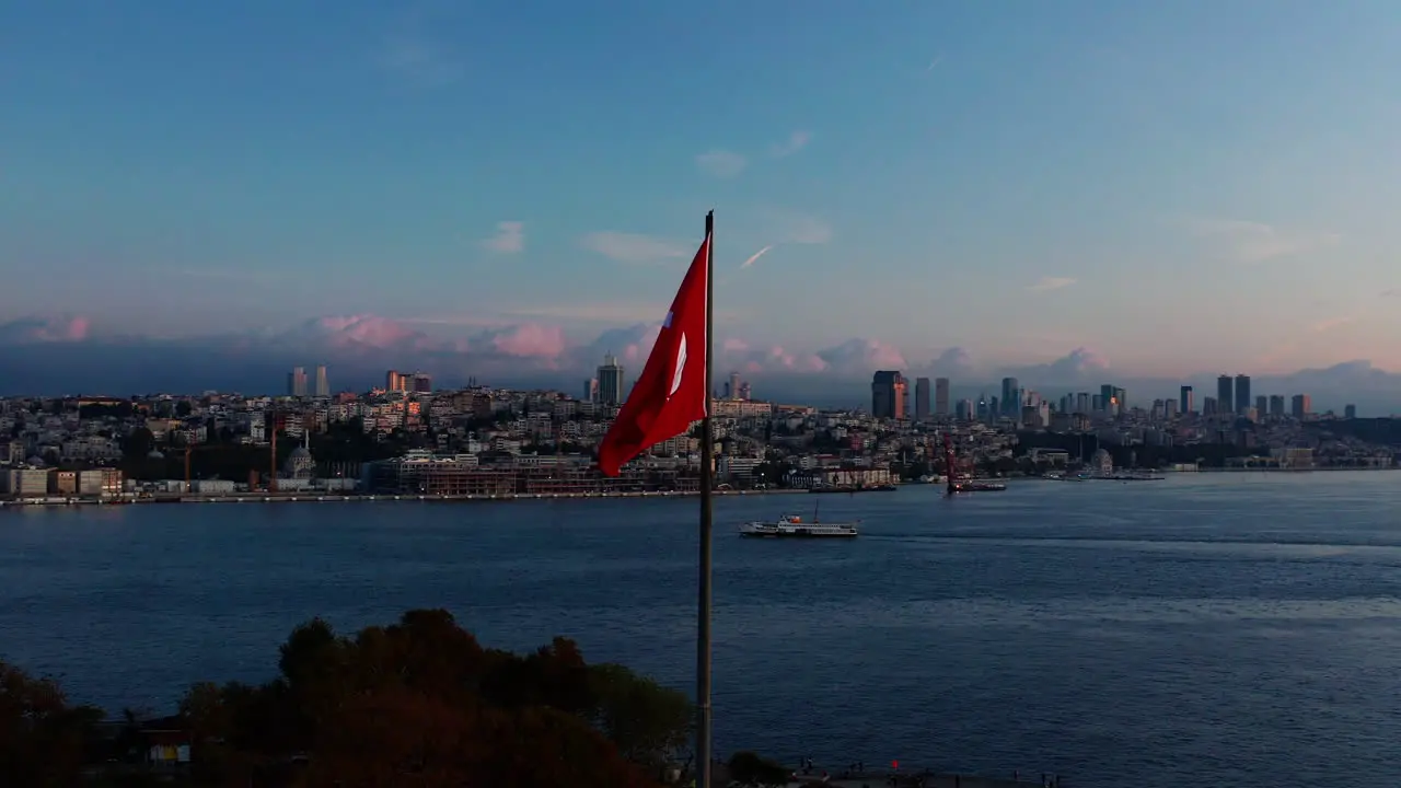 Aerial point of view shot of the Turkish flag flying over Istanbul at dawn