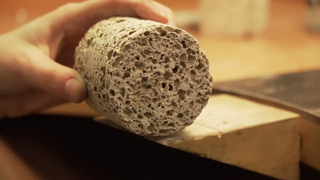 Shaking with concrete geopolymer cylinder because of dust in slow motion