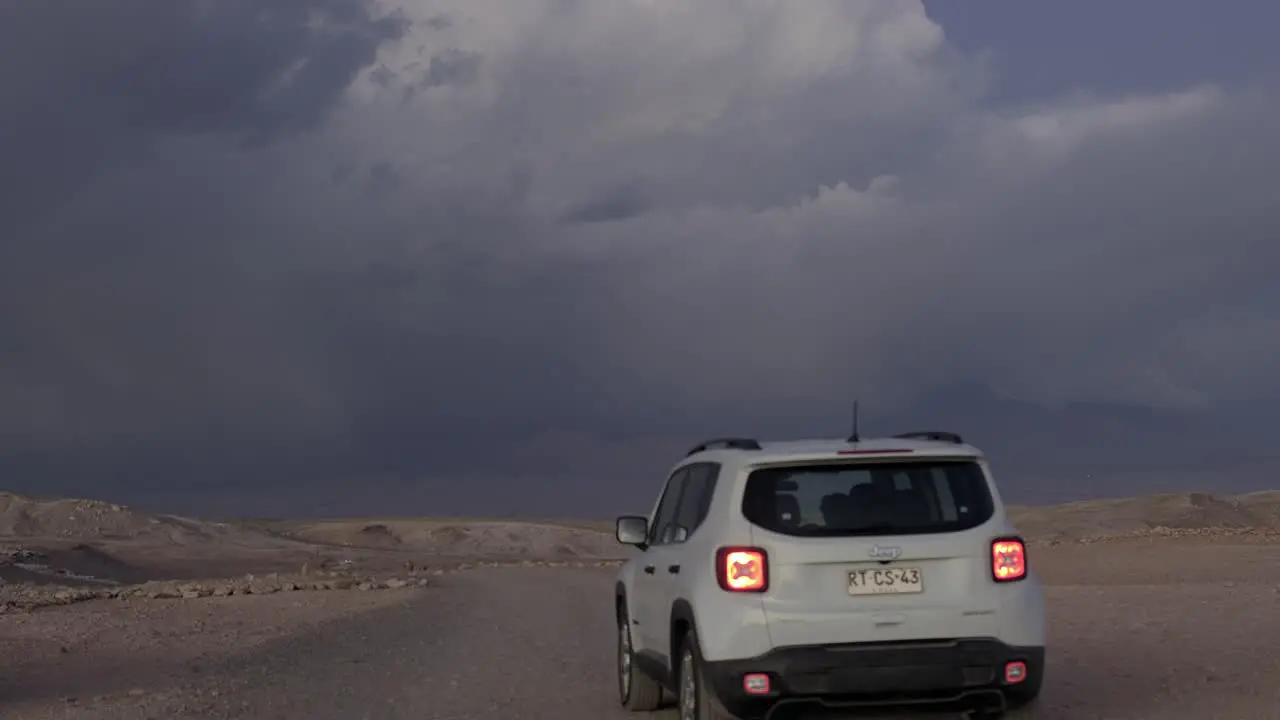 Car Driving Towards Lightning Bolt in the Atacama Desert Chile