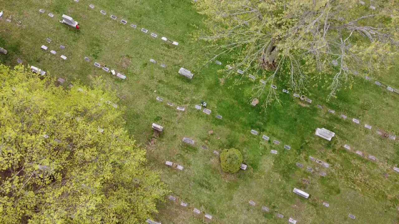 cemetery graveyard drone aerial footage Grand Rapids Michigan with green foliage and trees and gravestones