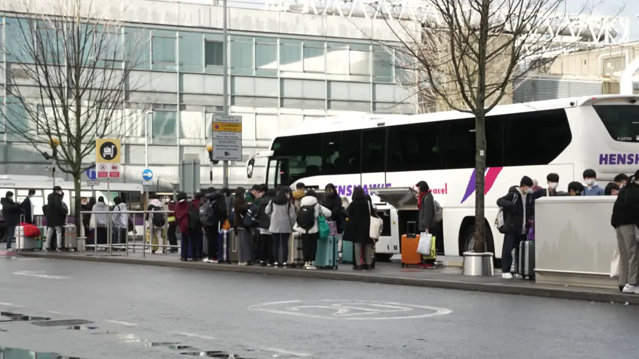 6 November 2022 Group Of Passengers Waiting Beside Coach At Drop Off Point At Heathrow Terminal 3