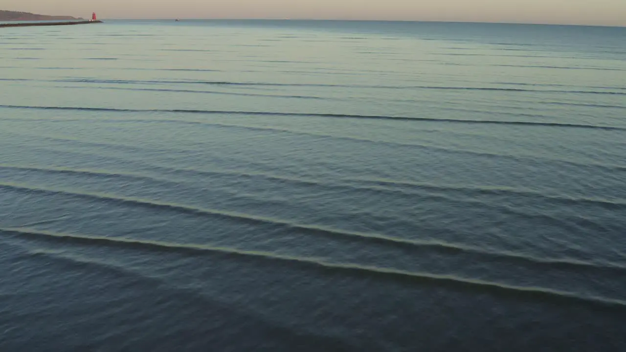 Abstract Aerial over beautiful low tide ocean waves at sunset background