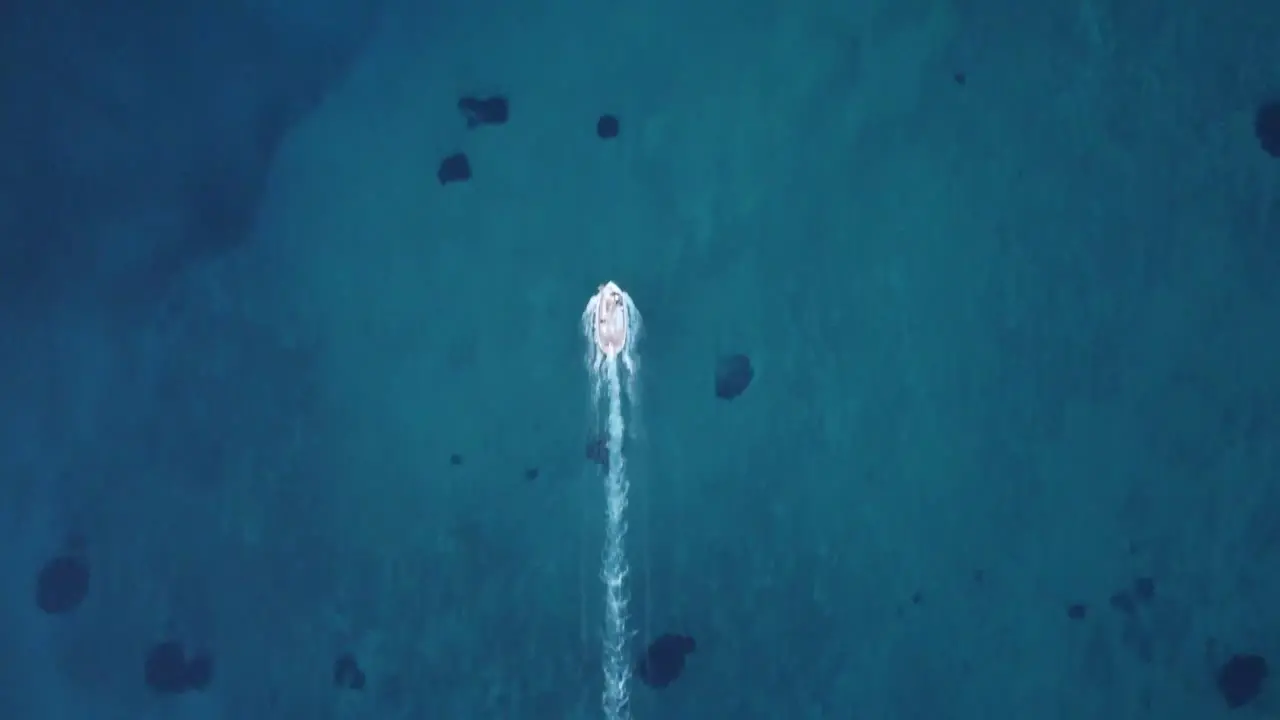 Cinematic fishermen boat leaving a long water trail behind it self